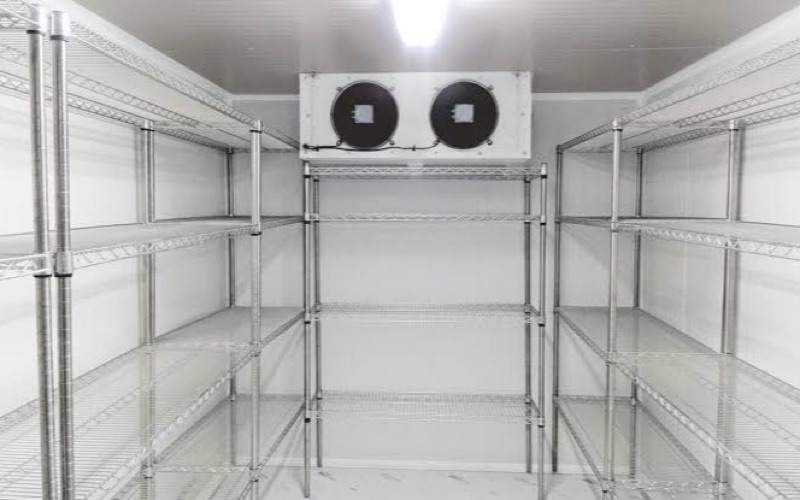 Commercial cool room interior with shelving and evaporator unit