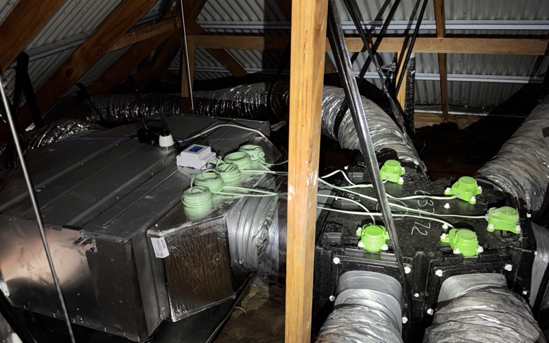 Insulated ducted air conditioning ductwork and fan coil installed in a roof space