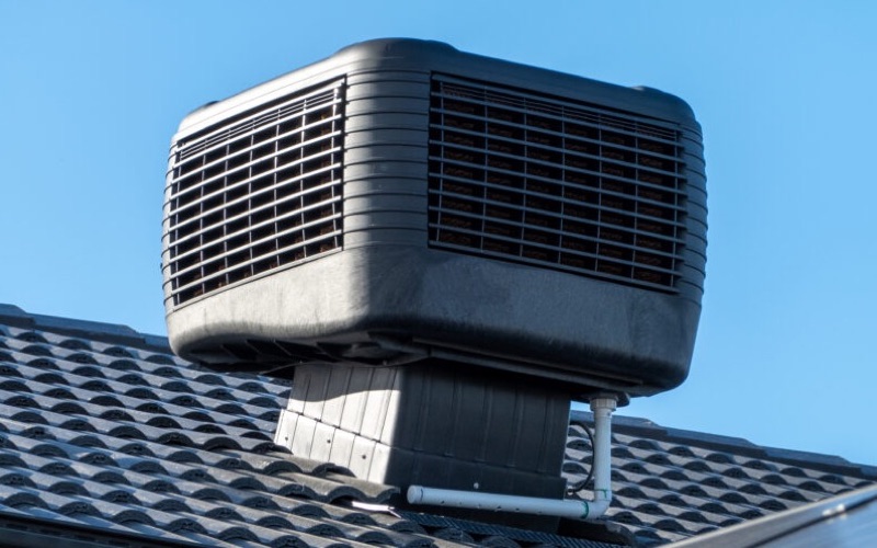 Evaporative cooling unit installed on a tiled roof