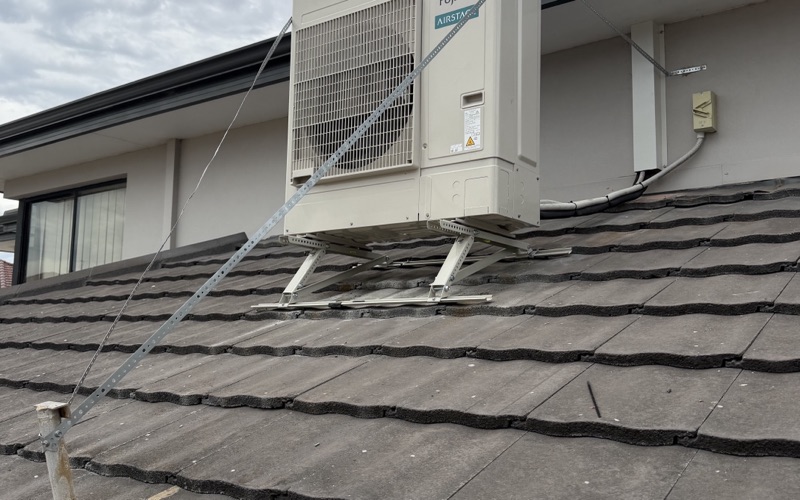 Fujitsu split system outdoor unit installed on roof brackets